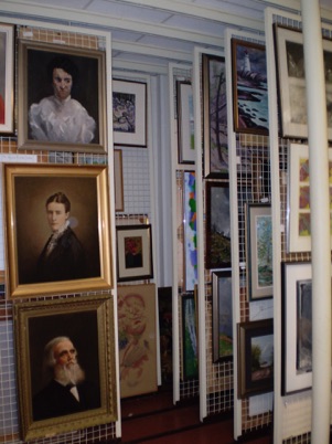 Many pieces of the Collection's visual works mounted on sliding storage racks.